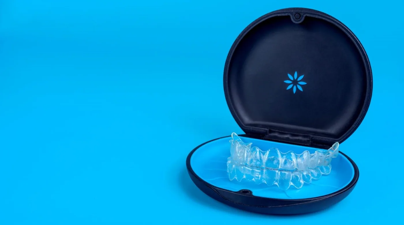 Invisalign clear aligners resting in their storage case, the removable and nearly invisible way to straighten teeth
