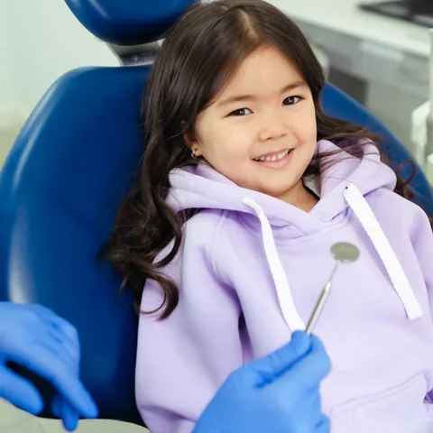 Young girl smiling in the dental chair during a children's check-up