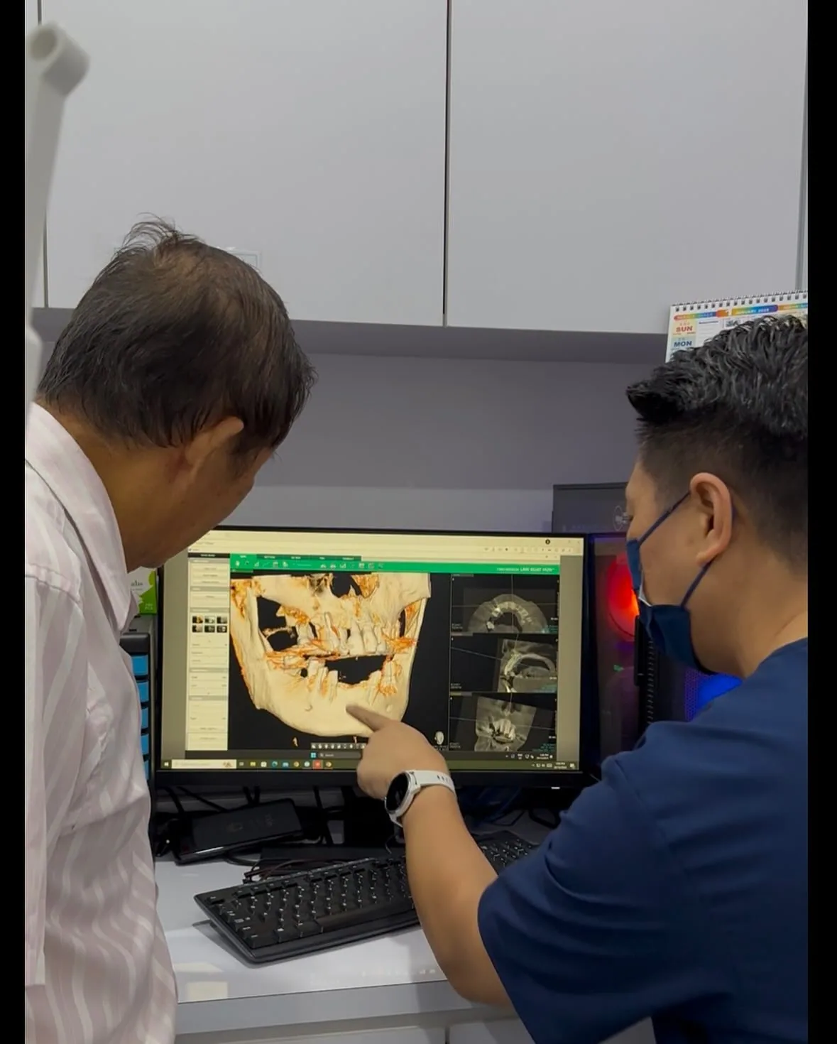 Dentists reviewing a 3D scan on screen while planning a full mouth rehabilitation to replace missing teeth and restore function