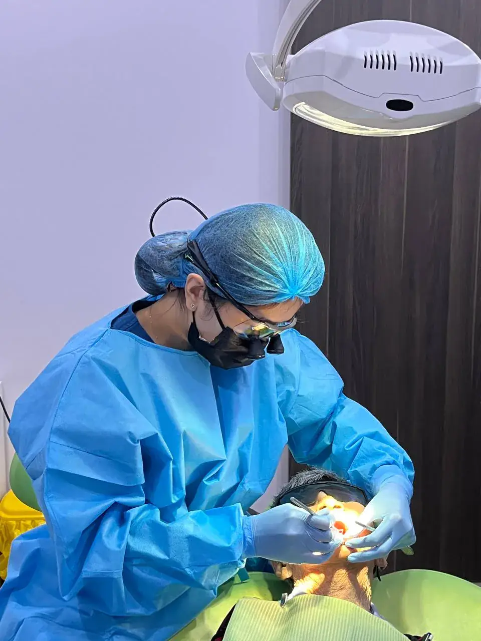 Dental surgeon performing a wisdom tooth removal at our Bukit Jalil clinic, relieving pain and protecting the neighbouring molar